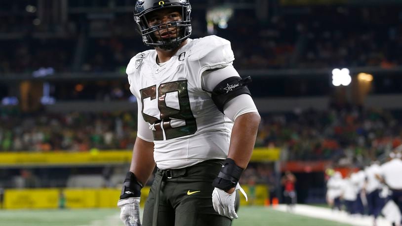 FILE - In this Aug. 31, 2019, file photo, Oregon offensive lineman Penei Sewell (58) looks on as Oregon plays Auburn in an NCAA college football game in Arlington, Texas. The last NFL event not impacted by the COVID-19 pandemic was the 2020 combine in Indianapolis. A year later, with the 2021 combine canceled, the league has released a list of players who would have merited invitations. From such high-profile quarterbacks as Clemson’s Trevor Lawrence and Ohio State’s Justin Fields to guys who sat out last season such as Oregon tackle Penei Sewell, there are 323 players from 100 schools. (AP Photo/Ron Jenkins, File)