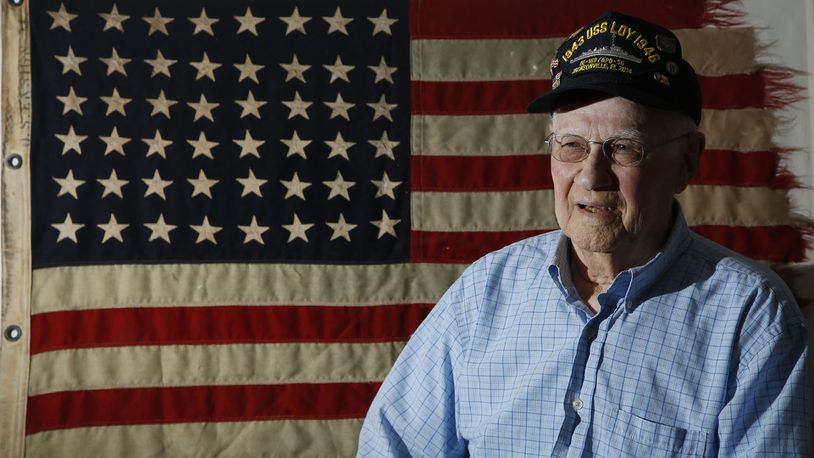 WWII Navy Veteran Baylor Kirk served on the USS Loy as an electrician in the Atlantic and Pacific.  Kirk has saved this flag that flew above the ship.  TY GREENLEES / STAFF