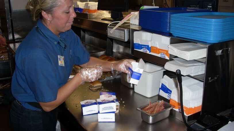 Angie Jordan, of Middletown, crew manager of the White Castle on Roosevelt Boulevard, bags hamburgers.