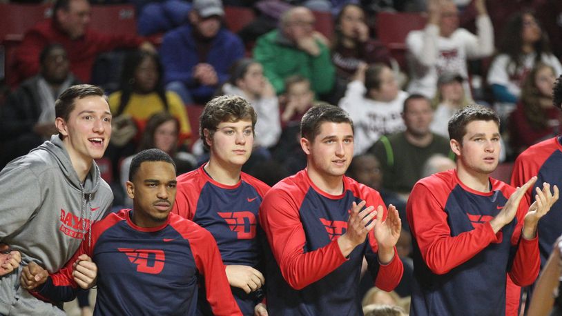 Dayton players react to a play during a game against Massachusetts on Saturday, Feb. 3, 2018, at the Mullins Center in Amherst, Mass. From left to right, they are: Ryan Mikesell, Camron Greer, Dalton Stewart, Jack Westerfield and Joey Gruden. David Jablonski/Staff