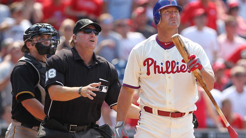 Philadelphia Phillies pinch hitter Jim Thome, right, joins umpire Brian Runge and Pittsburgh Pirates catcher Michael McKenry in watching a towering fly ball sail into foul territory at Citizens Bank Park in Philadelphia on June 28, 2012. (Michael Bryant/Philadelphia Inquirer/TNS)