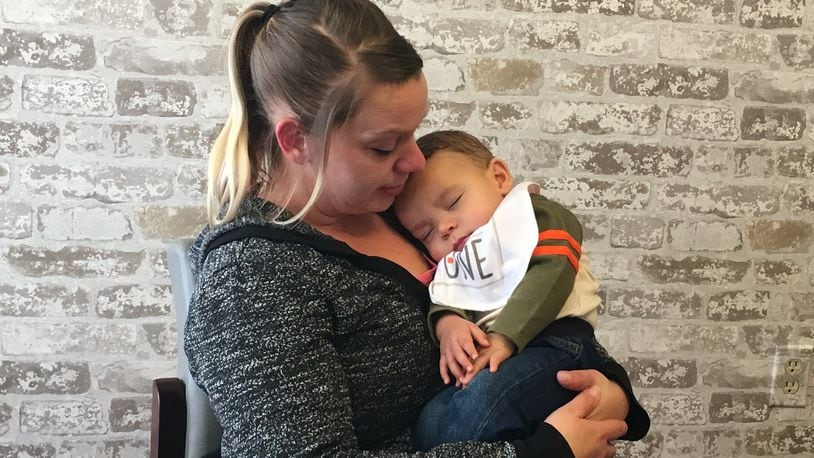 Jennifer Clay holds her son Jaden while talking about her decade-long battle with drug addiction. KATIE WEDELL/STAFF