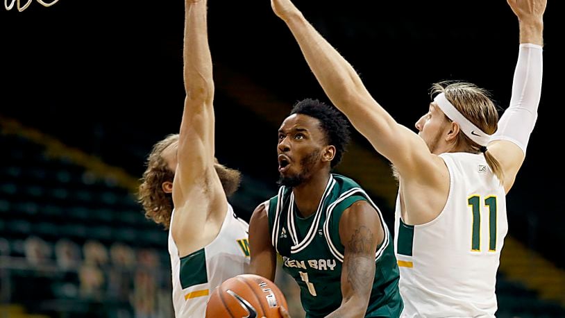 Green Bay guard Amari Davis goes up to score between Wright State’s Tim Finke and Loudon Love during a men's basketball game at the Nutter Center in Fairborn Saturday, Dec. 26, 2020. E.L. Hubbard/CONTRIBUTED