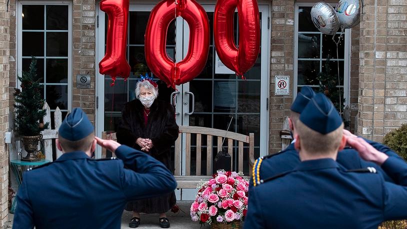 Air Force ROTC cadets salute Yolanda ‘Tipi’ Minnehan at her 100th birthday Dec. 23 in Fairborn. Minnehan served in the Army during World War II and was a longtime volunteer at Wright-Patterson Air Force Base. U.S. AIR FORCE PHOTO/R.J. ORIEZ