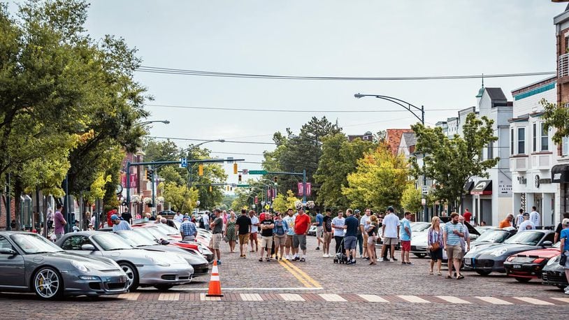 Porsches and people line High St. in Oxford during the 2019 Red Brick Reunion. Photo courtesy of Oxford Visitors Bureau