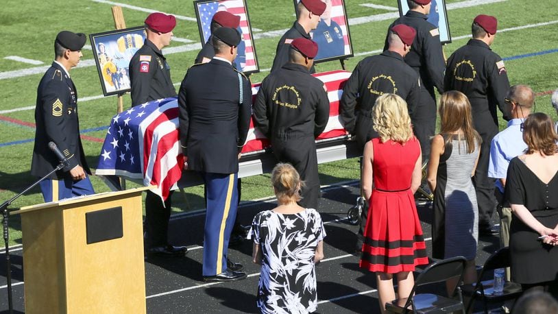 Members of the Army Golden Knights parachute team act as pallbearers during the funeral service for their team member Master Sgt. Corey Hood, a West Chester native who recently died following a skydiving accident in Chicago. The funeral was held at the football stadium of Lakota West High School, where Hood attended, Saturday, Aug. 22, 2015. Photo by Greg Lynch / Journal-News