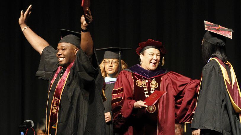 About 240 Central State University graduates received degrees Saturday at the Central State University Commencement at the Dayton Convention Center. University President Cynthia Jackson-Hammond, center, presents diplomas. CHRIS STEWART / STAFF