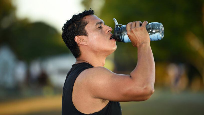 Drinking water or a sports drink should go hand in hand with exercise in the heat. CONTRIBUTED
