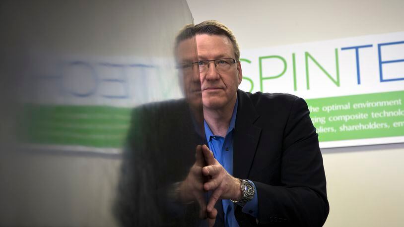 SpinTech president Craig Jennings is reflected in a large composite panel  his company produced for a leading rocket company. TY GREENLEES / STAFF