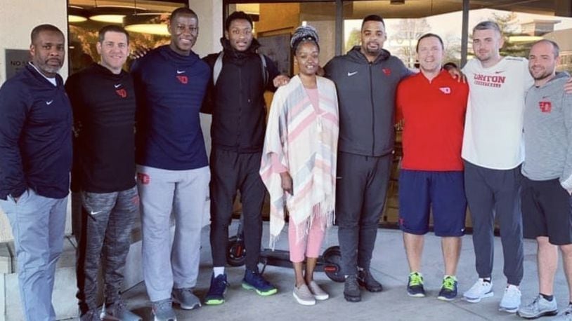 R.J. Blakney and his mom, Dafne’, pose with the Dayton coaching staff during their visit to campus. Submitted photo