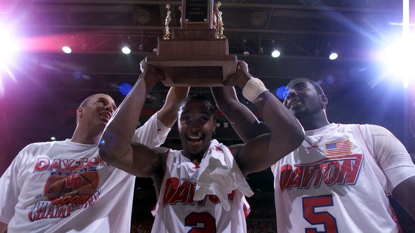 03/15/03  Dayton's Brooks Hall, D.J. Stelly, and Nate Green hold up the A-10 championship trophy after defeating Temple on Saturday afternoon.
