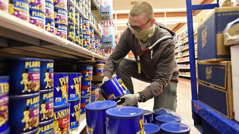 U.S. Air Force Airman Kevin Reed, 88th Air Base Wing Communications Squadron, stocks shelves as a volunteer at the Wright-Patterson Air Force Base commissary on April 9, 2020. (U.S. Air Force photo/Ty Greenlees)