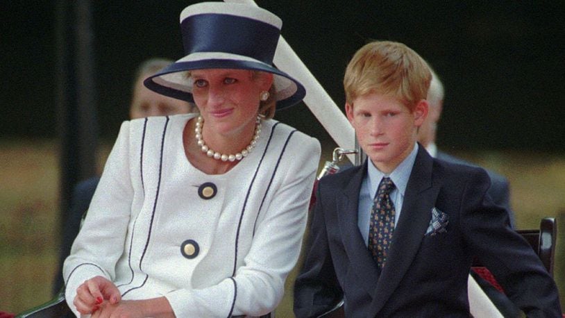 In this Aug. 19, 1995, file photo, Britain's Princess Diana, left, sits next to her younger son Prince Harry during V-J Day celebrations in London.