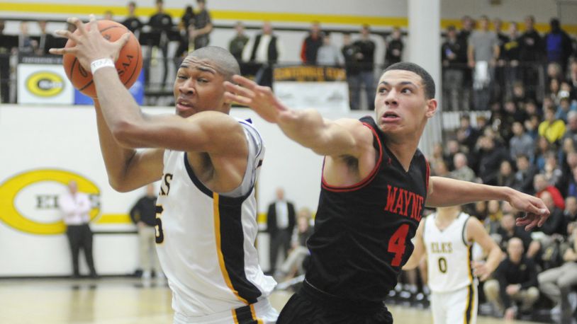 Wayne, including Brian Hill (right), had no answer for Centerville 6-9 center Mo Njie (with ball), who scored 16 points. Centerville defeated visiting Wayne 69-44 in a boys high school basketball game on Friday, Feb. 15, 2019. MARC PENDLETON / STAFF