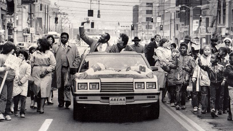 A parade for the two-time Olympic champion was held in downtown Dayton in 1984. Edwin C. Moses and his wife Myrella rode from Courthouse Square to Memorial Hall in a convertible with a patriotic banner covering the hood.More than 1,000 Dayton public school children walked alongside holding American flags high as Moses and his wife waved to the crowd on the streets. DAYTON DAILY NEWS ARCHIVE