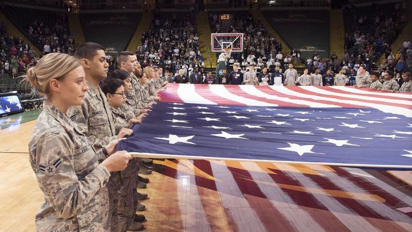 Airmen from Wright-Patterson Air Force Base hold a large American flag during a pregame ceremony prior to a Wright State University basketball game Jan. 26 at the Nutter Center. The college hosted a military appreciation night. (U.S. Air Force photo/R.J. Oriez)