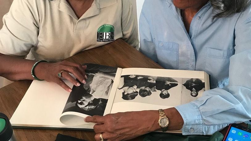 Jacqueline Colvard, left, and Marilyn Miller-Lewis look over their Ohio University memorabilia as they plan for an October 27 alumni event at the Paul Laurence Dunbar House. CONTRIBUTED
