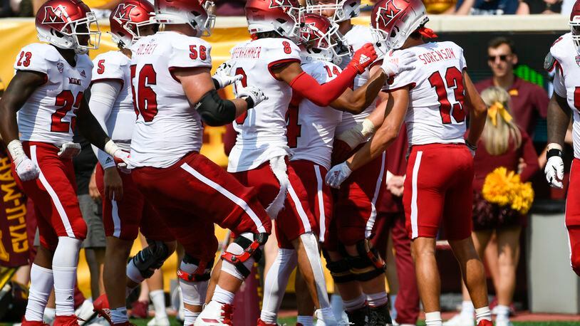 Miami-Ohio Wide Receiver Jack Sorenson (13) celebrates with his teammates after catching a 23-yard pass for a touchdown during the second half of an NCAA college football game against Minnesota, Saturday, Sept. 11, 2021, in Minneapolis. Minnesota won 31-26. (AP Photo/Craig Lassig)