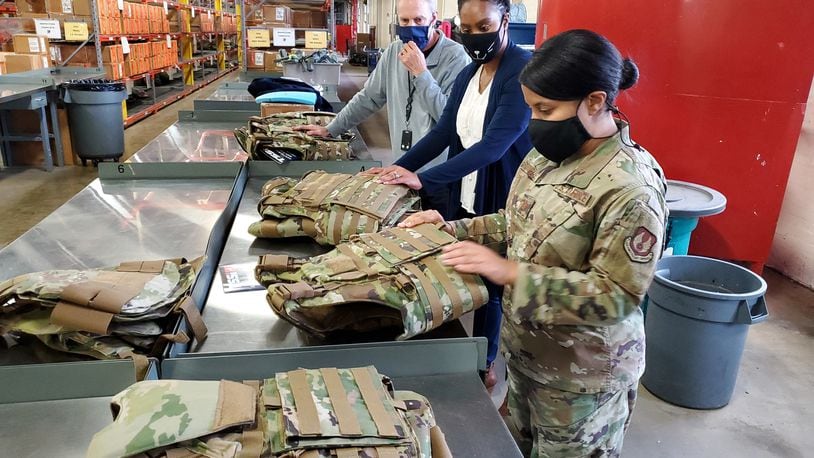 Dr. Daniel Mountjoy (left), Christine Villa, and Maj. Saily Rodriguez, with the Air Force Life Cycle Management Center's Human Systems Division, perform an inspection on new body armor units designed specifically for female Airmen in Security Forces. (U.S. Air Force photo / Brian Brackens)
