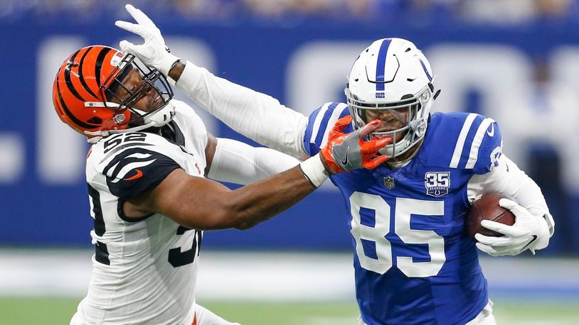 Cincinnati Bengals linebacker Preston Brown (52) tries to bring down Indianapolis Colts tight end Eric Ebron (85) on this first half play on Sunday, Sept. 9, 2018 at Lucas Oil Stadium in Indianapolis, Ind. (Sam Riche/TNS)