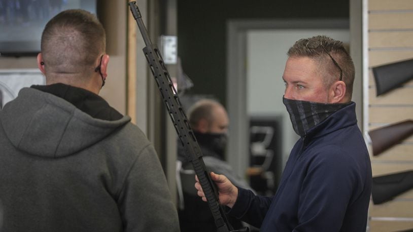 David Becker, owner of Miami Armory gun shop near the Dayton Mall, talks to a customer Thursday Jan. 14, 2021.Becker said the new gun owners are from all walks of life. His shop has seen more women shooters in recent years. Becker said recently he has seen people who would generally be anti-gun come into his shop. JIM NOELKER