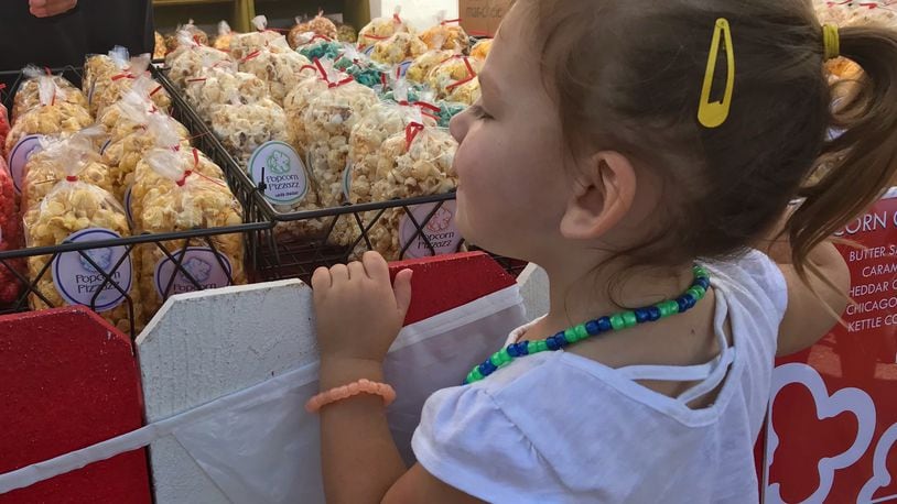 Festivalgoers were not afraid to get their hands sticky as flavored popcorn of every variety filled Dayton-Xenia Road for the 33rd Beavercreek Popcorn Festival on Saturday and Sunday, Sept. 7 & 8, 2019. SARAH FRANKS/STAFF