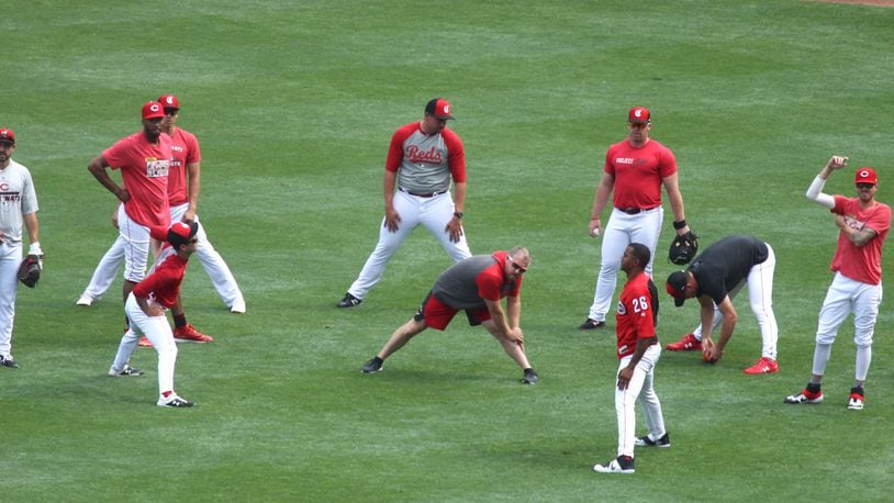Reds relievers stretch before a game against the Cardinals on Thursday, Aug. 15, 2019, at Great American Ball Park in Cincinnati.