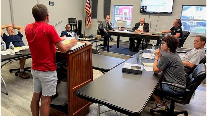 Harveysburg Village Council hears a report during its meeting on Monday, Sept. 11, 2023. At that meeting, council adopted a new building permit fee schedule that goes into effect on Oct. 11, 2023.  ED RICHTER/STAFF