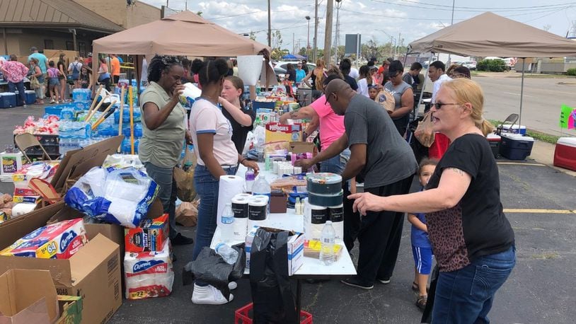 In early June, volunteers in Old North Dayton gave out free food, water and other supplies to victims of the Memorial Day tornadoes. STAFF / DREW TANNER