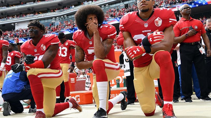SANTA CLARA, CA - OCTOBER 02: (L-R) Eli Harold #58, Colin Kaepernick #7 and Eric Reid #35 of the San Francisco 49ers kneel on the sideline during the anthem prior to the game against the Dallas Cowboys at Levi’s Stadium on October 2, 2016 in Santa Clara, California. (Photo by Thearon W. Henderson/Getty Images)