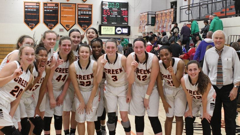 Beavercreek High School girls basketball members huddle with coach Ed Zink (right) after he coached his 1,000th game. Beavercreek defeated visiting Northmont 65-38 on Wed., Jan. 10, 2018. RANDY WIMER / CONTRIBUTED