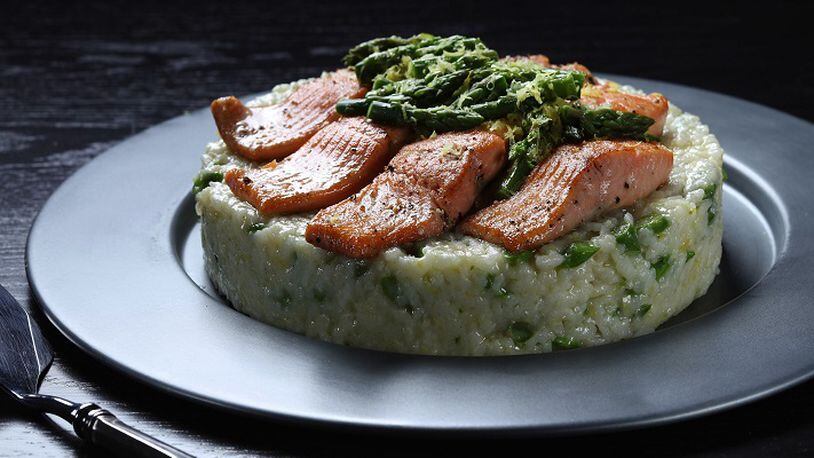 Italian rice salads, a staple of the country's cuisine but not well known here, get plenty of attention in chef John Coletta's book "Risotto & Beyond." This version features an asparagus-studded mold of rice, topped with trout and an asparagus relish. (Abel Uribe/Chicago Tribune/TNS)