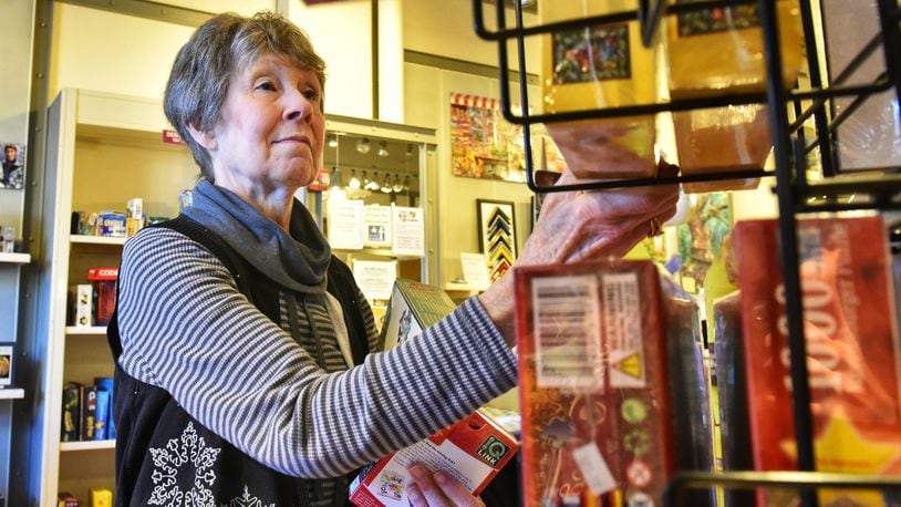 Pat Kothman shops for gifts at Puzzles Plus at The Greene Town Center in Beavercreek Thursday, Dec. 19. NICK GRAHAM/STAFF