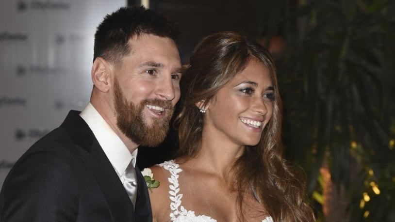 Lionel Messi and Antonela Roccuzzo greet the press after their civil wedding ceremony at the City Center Rosario Hotel & Casino on Friday.