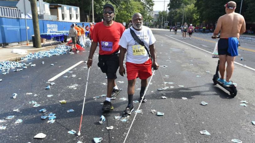 Brothers Willard J. Walker and John W. Smith, are legally blind and completed the Peachtree Road Race recently. (Photo: The Atlanta Journal-Constitution)