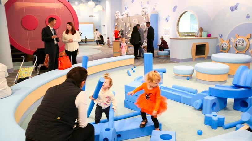Shoppers visit the children’s area in the Foundry at Liberty Center. A new event space coming to Liberty Center will offer babysitting services when it’s not hosting parties.