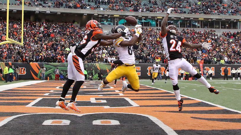 Antonio Brown of the Steelers couldn't catch this pass while being defended by the Bengals' Shawn Williams (#36) and Adam Jones during the third quarter at Paul Brown Stadium on December 18, 2016.