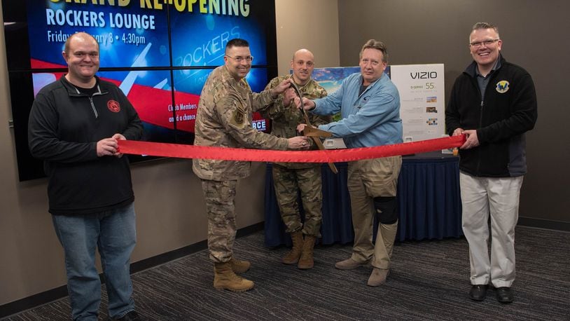 Col. Thomas P. Sherman, 88th Air Base Wing commander, along with Chief Master Sgt. Stephen A. Arbona, 88 ABW command chief, and Bruce Hiott, Wright-Patterson Club general manager, cut the ribbon to open the newly redesigned Rockers Lounge inside the club Feb. 8. The Rocker Lounge is a new area for Airmen and their families to relax in an updated atmosphere. (U.S. Air Force photo/Staff Sgt. Ashley Clingerman)