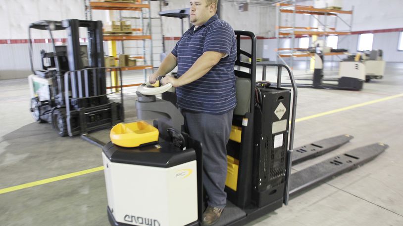 Steve Jutte, lead service technician at Crown Equipment Corporation’s Huber Heights Project Center, operates a hydrogen fuel cell-powered pallet truck in this 2010 file photo. FILE