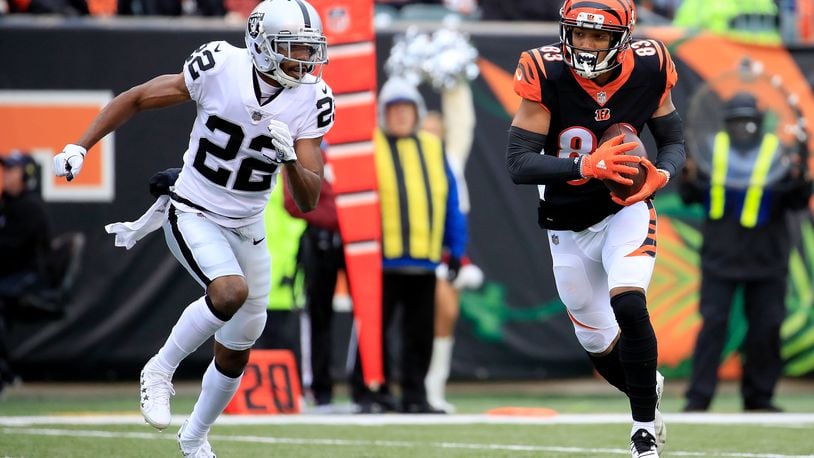 CINCINNATI, OH - DECEMBER 16: Tyler Boyd #83 of the Cincinnati Bengals catches a pass while being defended by Rashaan Melvin #22 of the Oakland Raiders during the first quarter at Paul Brown Stadium on December 16, 2018 in Cincinnati, Ohio. (Photo by Andy Lyons/Getty Images)
