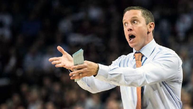 Florida head coach Mike White communicates with players during the first half of an NCAA college basketball game against South Carolina Wednesday, Jan. 18, 2017, in Columbia, S.C. (AP Photo/Sean Rayford)