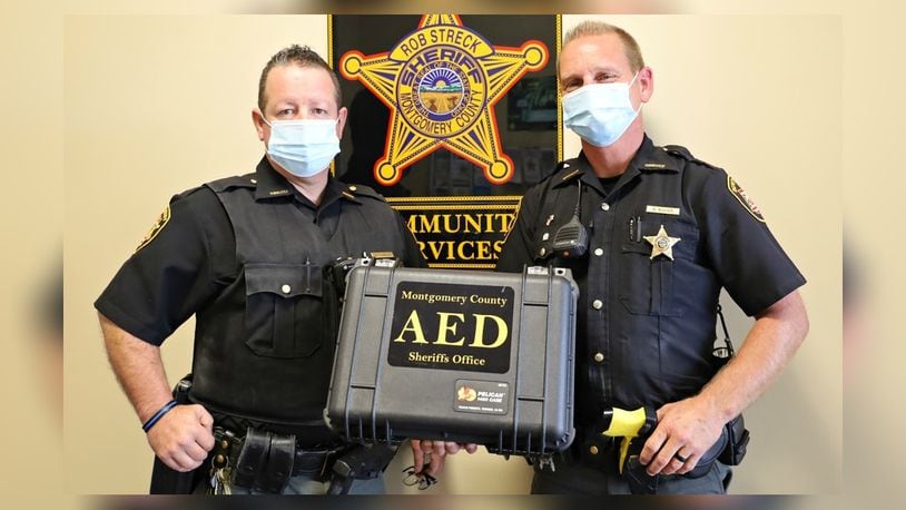 Montgomery County Sheriff's deputies Gust Teague, left, and Brandon Baker, right, used a defibrillator to help save the life of a utility worker who suffered an electric shock Sept. 9, 2020, while working  on power lines in the backyard of a Jefferson Twp. home.
