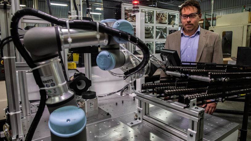 Brian Pelke, president of Kay Manufacturing, an automotive parts company in Calumet City, Ill., looks at their newest Universal Robot on Wednesday, Sept. 12, 2018. The manufacturing company has been incorporating collaborative robots, widely known as cobots, into its production process. The Universal Robots are used mostly for end-of-line tasks, packaging and palletizing parts off a conveyor. (Zbigniew Bzdak/Chicago Tribune/TNS)