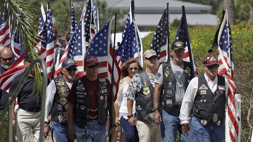 A motorcycle group carries American flags during funeral service for U.S. Army veteran Edward K. Pearson Oct. 1, 2019, at the Sarasota National Cemetary in Sarasota, Fla. Pearson had no family but thousands who appreciated his service bid farewell.