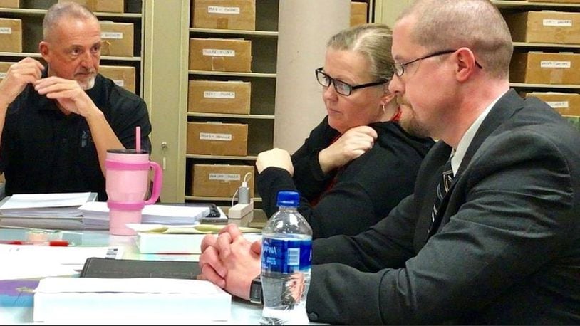 Miami County Board of Elections members talk Thursday night at a meeting. Shown from left are David Fisher, Audrey Gillespie and Rob Long. The fourth board member, Ryan King, was out of town and did not attend. STAFF