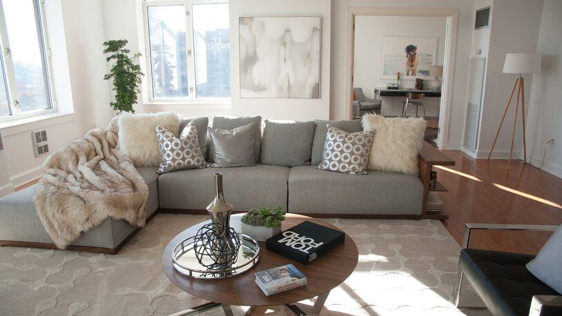 A low, light colored sectional sofa helps keep this living room open and bright. (Hannah Rokes)