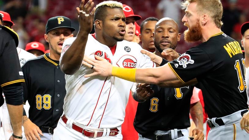 CINCINNATI, OHIO - JULY 30: Yasiel Puig #66 of the Cincinnati Reds is restrained during a bench clearing altercation in the 9th inning of the game against the Pittsburgh Pirates at Great American Ball Park on July 30, 2019 in Cincinnati, Ohio. (Photo by Andy Lyons/Getty Images) *** BESTPIX ***
