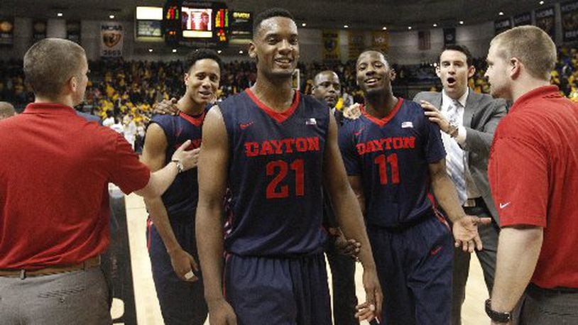Dayton’s Dyshawn Pierre and the Flyers leave the court after a victory against Virginia Commonwealth on Saturday, Feb. 28, 2015, at the Siegel Center in Richmond, Va. David Jablonski/Staff