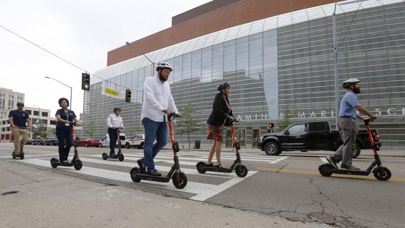 Shared mobility devices are regulated in some cities, including Dayton (above), while others, including Oakwood, have banned them. FILE