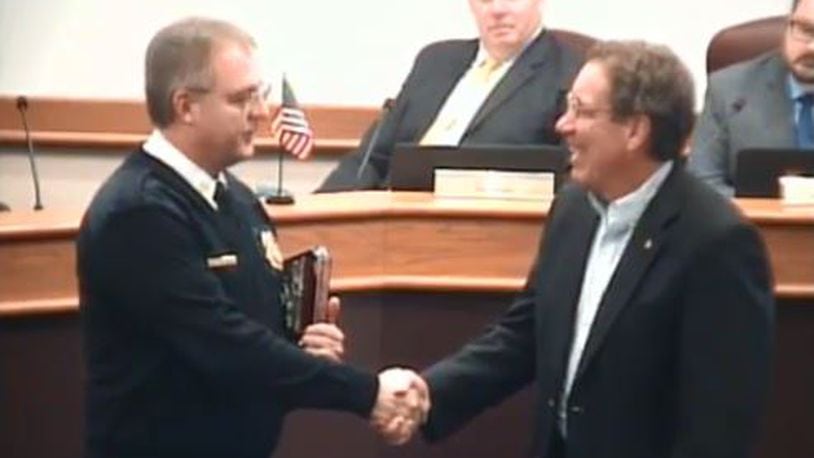 Huber Heights Fire Division Chief Mark Ashworth shakes hands with retiring fire chaplain Pastor Dennis Dobbins. CONTRIBUTED